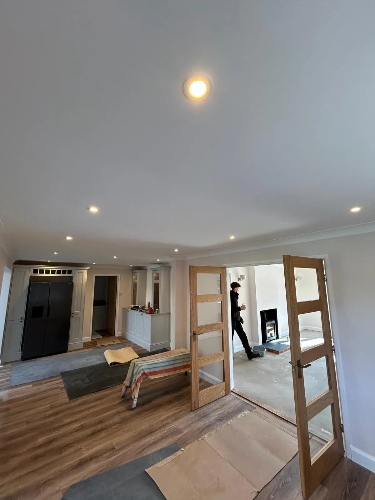 Finished open plan kitchen and living space with recessed ceiling lighting